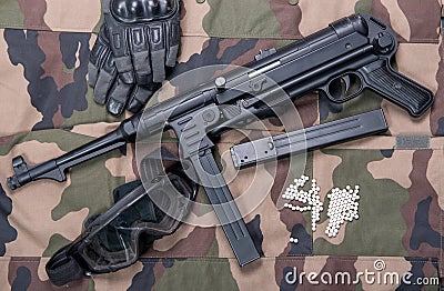 Airsoft rifle with protective glasses, gloves and white bullets Stock Photo