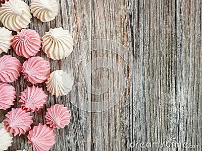 the airy meringue white and pink lies on a light Desk in rows and columns. Stock Photo