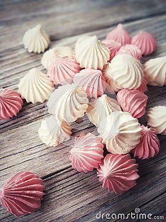 the airy meringue white and pink lies on a light Desk in rows and columns. Stock Photo