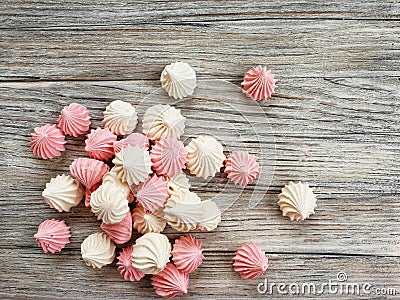 the airy meringue white and pink lies on a light Desk in rows and columns. Stock Photo