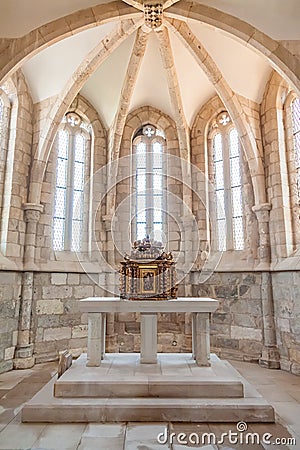 The aisle, altar and a gilded baroque tabernacle in the medieval church of Santa Cruz. Editorial Stock Photo