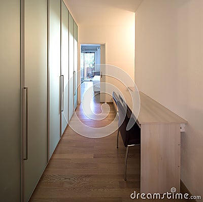 Aisle with desk, chair and closet Stock Photo