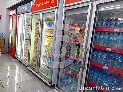 Aisle with various kinds of drinks on the Freezer shelves inside Alfamart Editorial Stock Photo
