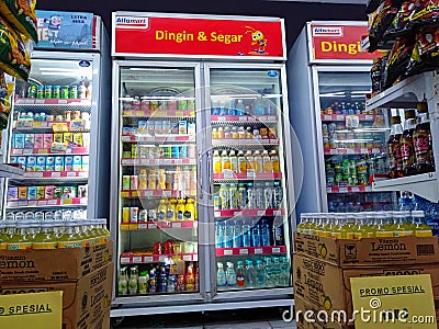 Aisle with various kinds of drinks on the Freezer shelves inside Minimarket Editorial Stock Photo