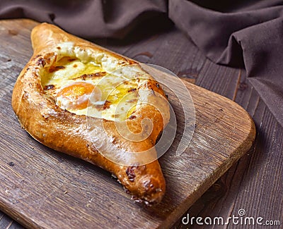 Ajarian traditional flatbread - khachapuri or hachapuri with egg and cheese. Copy text area for menu design or recipe book text Stock Photo