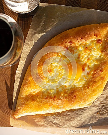 Ajarian traditional flatbread - khachapuri or hachapuri with egg and cheese. Stock Photo