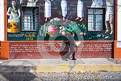 Ajijic, Jalisco, Mexico - January 15, 2021: A woman cleans the city government building in the town center of Ajijic. Editorial Stock Photo