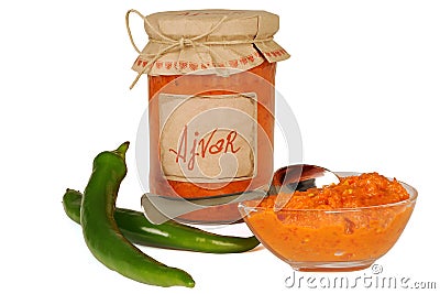 Ajvar - delicious dish of red and green peppers, onions, garlic, eggplant. Ajvar in jar. Stock Photo