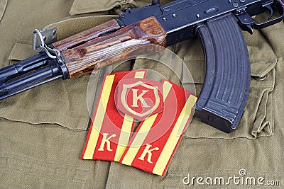 AK 47 with Soviet Army Cadet shoulder mark and Commandant shoulder patch on khaki uniform background Stock Photo