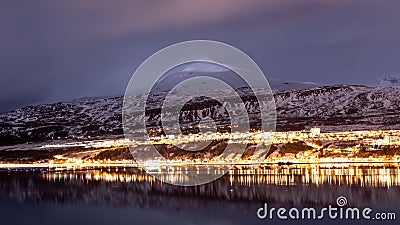 Akureyri, Iceland city lights during blue hours with a backdrop of ice mountains Stock Photo