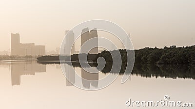Al Bahr Towers and Mangroves reflection in the sea Editorial Stock Photo