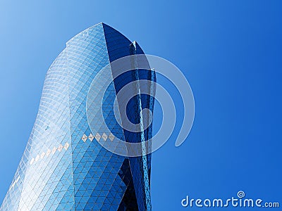 Al Bidda Tower against clear blue sky, close up. Modern skyscraper with glazed facade Stock Photo
