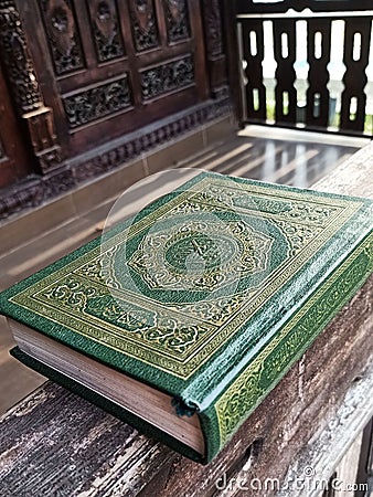 The holy Qur'an with wooden house background Editorial Stock Photo