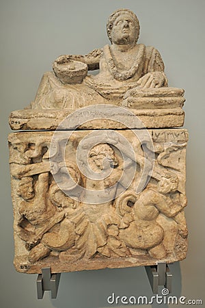 Alabaster cinerary urn with the figure of a man reclining on the lid and a carved panel on the chest at the British Museum Editorial Stock Photo