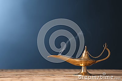 Aladdin lamp of wishes on wooden table a Stock Photo