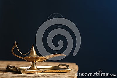 Aladdin lamp of wishes on wooden table Stock Photo
