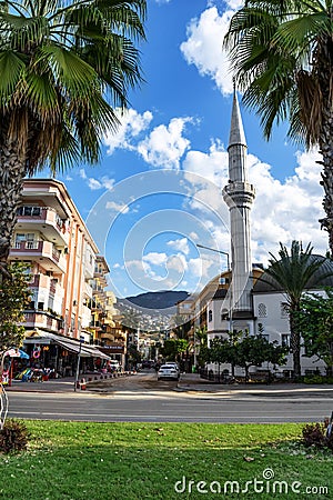 Alanya tropical cityscape with Hasan Senli Saray Cami Mosque on Belen Sk Street. Exotic Muslim Editorial Stock Photo