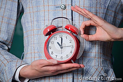 Alarm clock in hands of teacher or educator classroom background. School discipline concept. Schedule and regime. Right Stock Photo