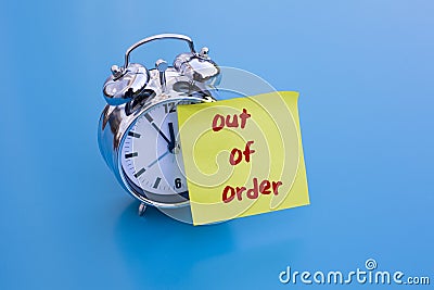 Alarm clock with note 'out of order' Stock Photo
