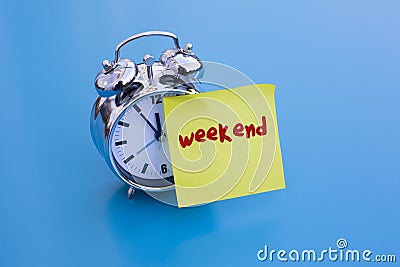 Alarm clock with note 'weekend' Stock Photo