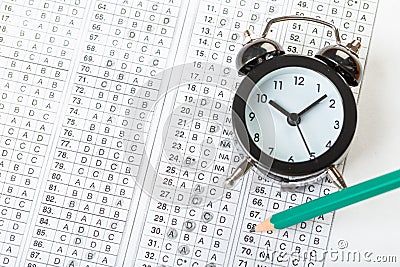 Alarm clock, optical form of standardized school test with bubble and black pencil, answer sheet, education concept Stock Photo