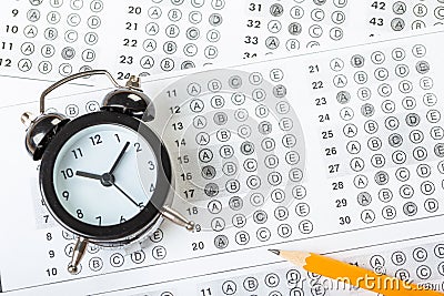 Alarm clock, optical form of standardized school test with bubble and black pencil, answer sheet, education concept Stock Photo