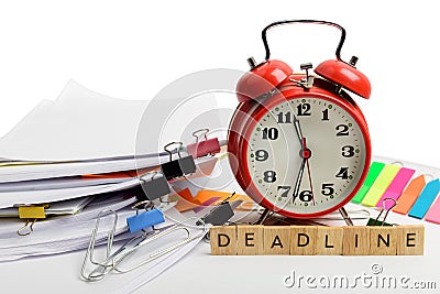 Alarm clock, over pile various documents Deadline business and finance concepts Stock Photo