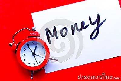 Alarm clock and paper sticker with the text money Stock Photo