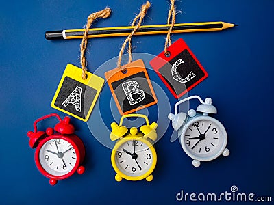 Alarm clock,pencil and wooden board Stock Photo