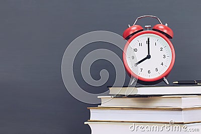 Alarm clock red,pen on book, stationery Stock Photo