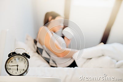 Alarm clock ringing.Woman waking up in early morning for work.Obstructive sleep apnea effects.Mental stress sleep depression. Stock Photo