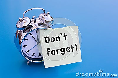 Alarm clock with sticker with words Dont Forget Stock Photo