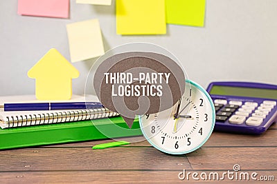 alarm clock and third-party logistics on black lettering Stock Photo