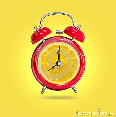 Alarm clock twin Bell-type red with fresh yellow lemon background Stock Photo