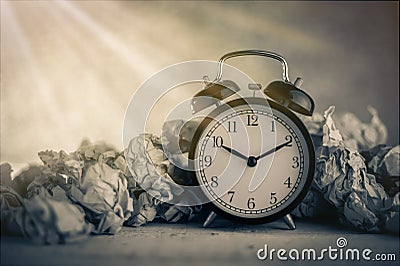 Alarm clock in a wastepaper Stock Photo