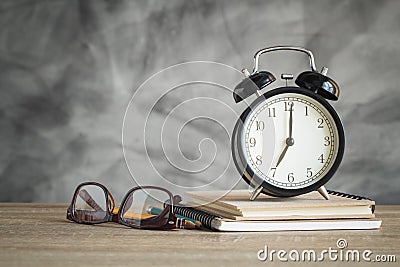 Alarm clock on wood table with school supplies , back to school Stock Photo