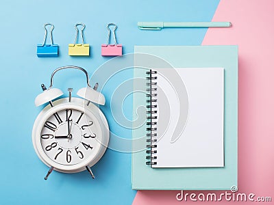 Alarm with supplies on color block background. Pastel minimalism Stock Photo