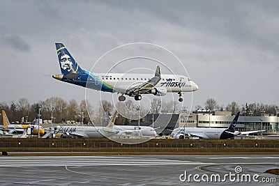 Alaska Airlines Embraer ERJ 170-200 jet landing at Everett Paine Field Editorial Stock Photo
