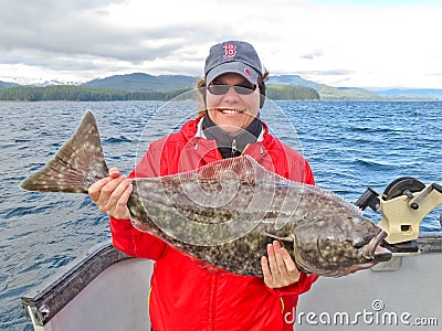 Alaska - Happy Smiling Woman Holding Halibut Editorial Stock Photo