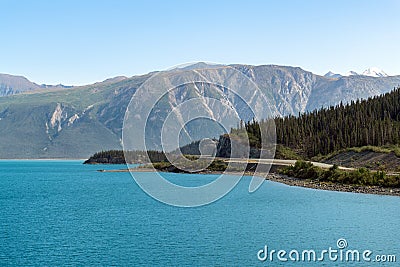 The Alaska Highway runs along the shoreline of Lake Kluane in Yukon, Canada Stock Photo