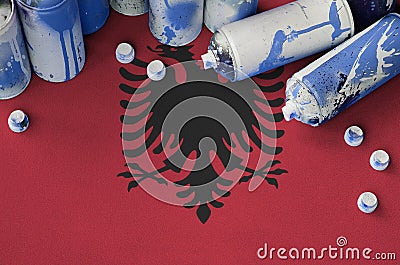 Albania flag and few used aerosol spray cans for graffiti painting. Street art culture concept Stock Photo