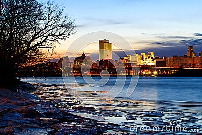 Albany NY skyline at night reflections off the Hudson River Stock Photo