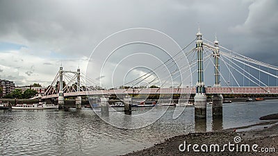 Albert Bridge over river Thames in London on gray overcast day. Stock Photo