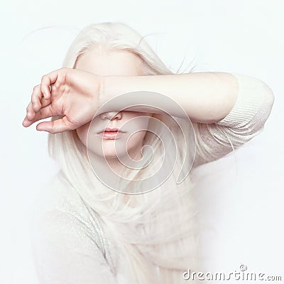 Albino girl with white pure skin, natural lips and white hair. Photo face on a light background. Portrait of the head. Blonde girl Stock Photo