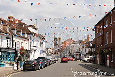 Alcester High Street, Shakespeare Country, Warwickshire, UK, in the summer with red, white and blue bunting across the street. Editorial Stock Photo