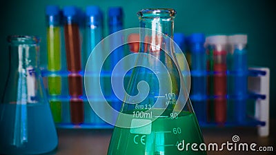 The alchemist checks the test tubes with a test of different compositions, in a white coat, a respirator, goggles, rubber white gl Stock Photo