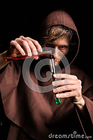 Alchemist in chemical laboratory prepares magical liquids Stock Photo