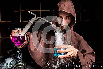 Alchemist in chemical laboratory prepares magical liquids Stock Photo