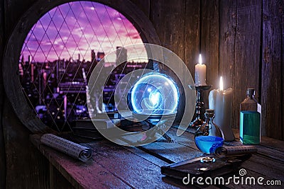 Alchemist concept. Crystal mystic ball, Spell book, magic ring, magic potions bottles, burning candle and other various Stock Photo