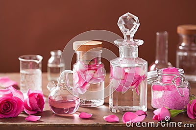 Alchemy and aromatherapy set with rose flowers and flasks Stock Photo